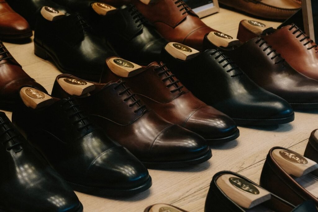 Close-up of luxury leather shoes arranged neatly in a store for sale.