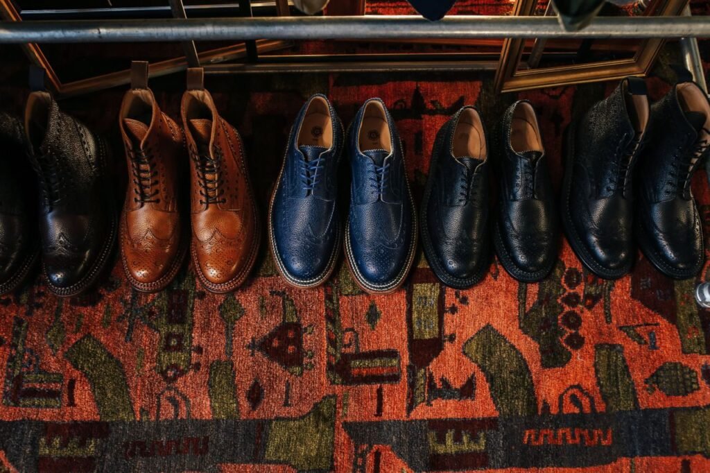 A collection of classic leather shoes displayed on a colorful vintage carpet, showcasing elegant fashion.